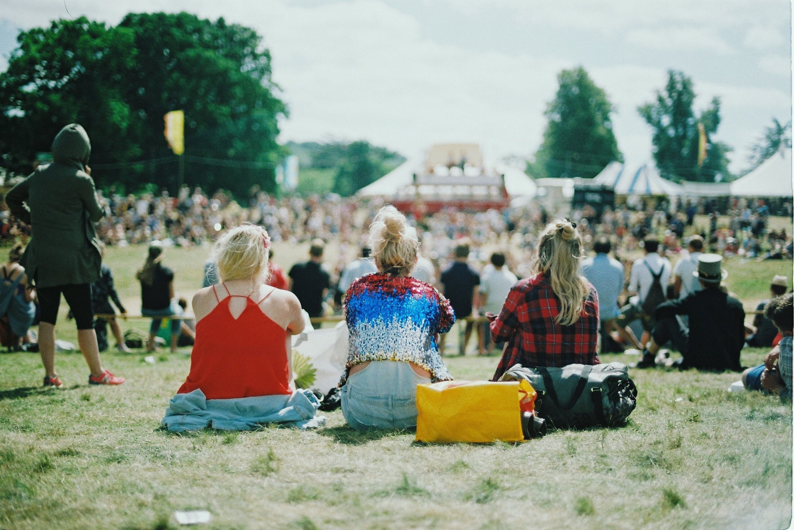 Things to do in East Cambridgeshire - Events. Stock photo of festival goes on grass from behind with soft focus on crowd in front of them