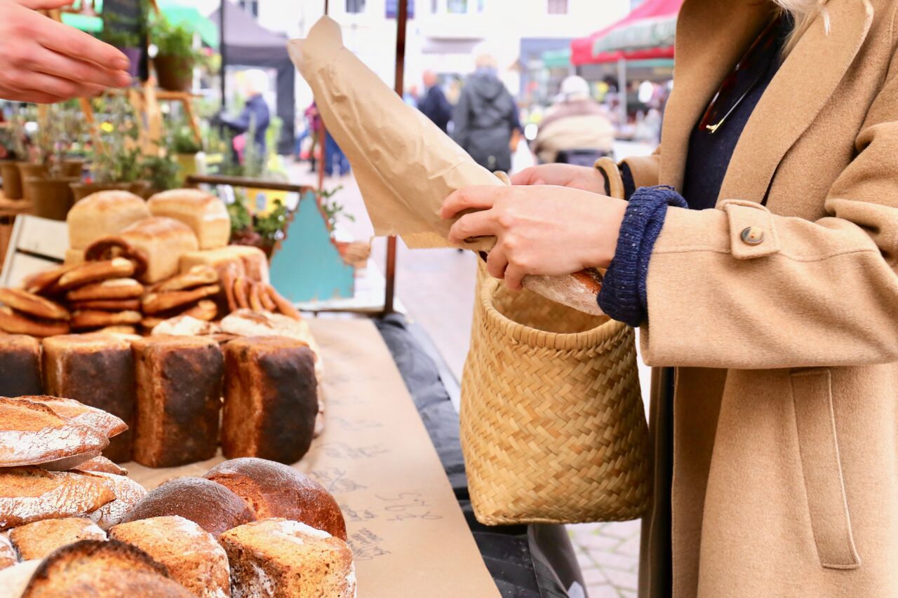Things to do in East Cambridgeshire - Families. Ely Market. Close up of baguette being purchased from a market stall