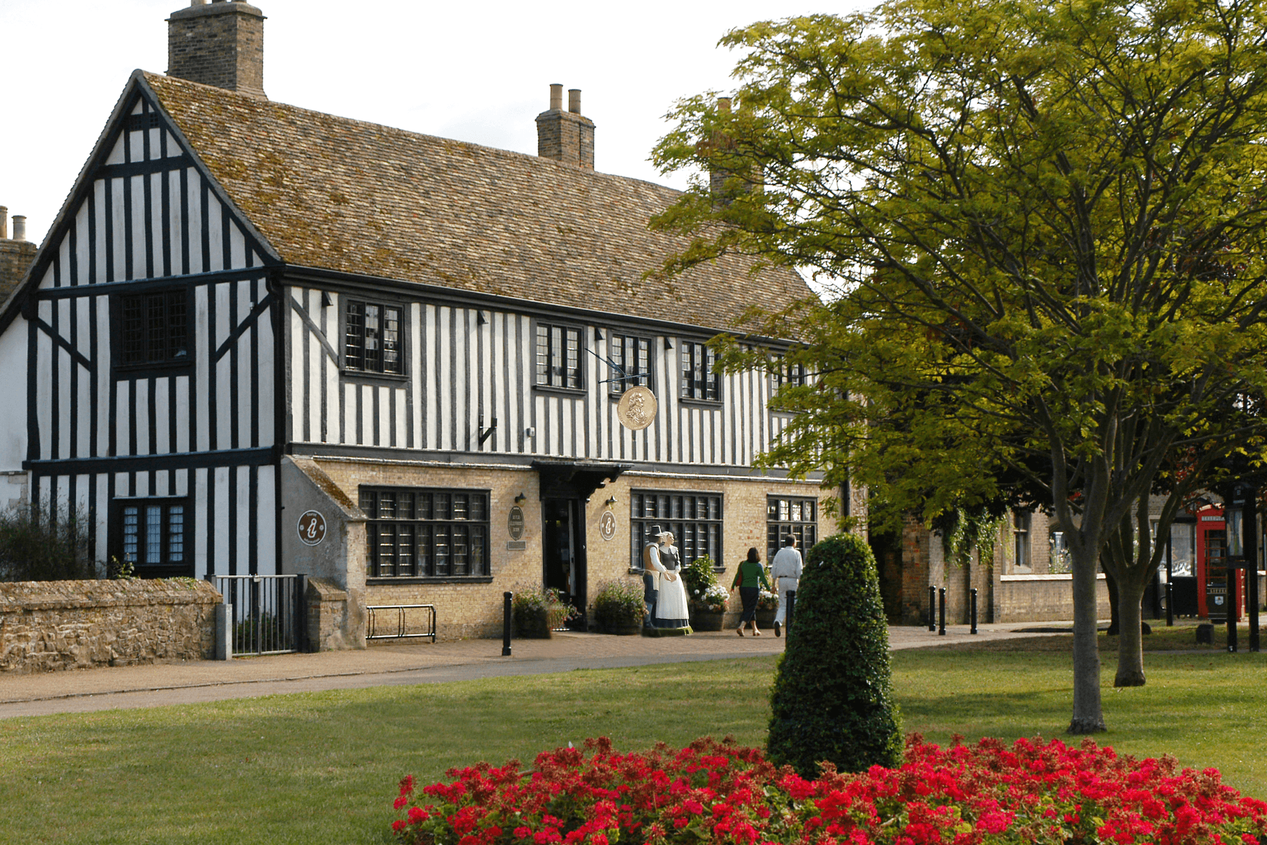 Things to Do in East Cambs - Oliver Cromwells House. Exterior of a Stewart House with flowerbeds in garden