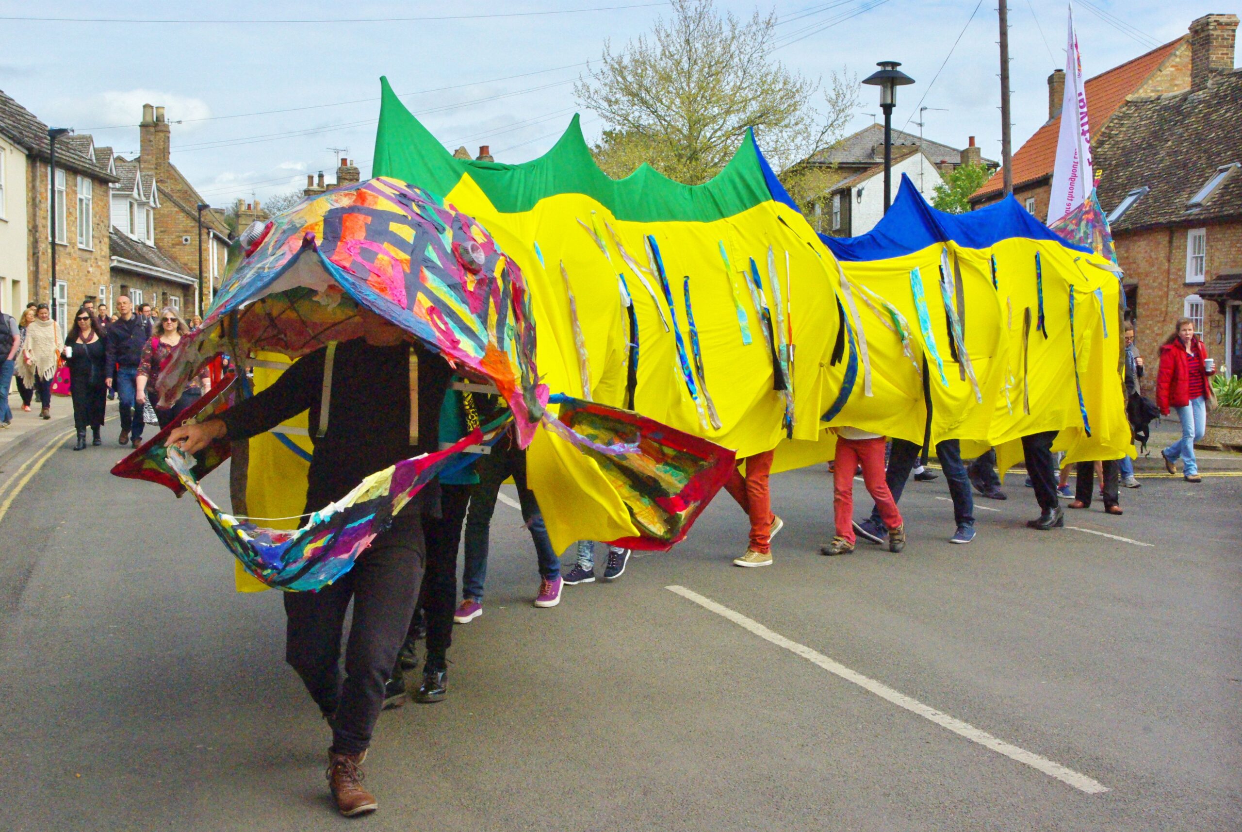 Things to do in East Cambs in Spring - Eel Fest. Giant eel puppet with people operating it.