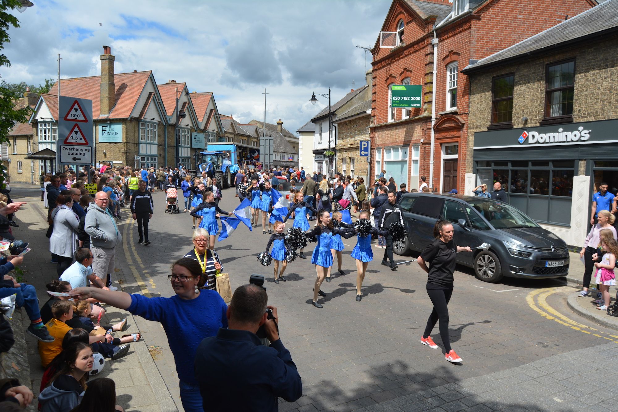 Things to do in East Cambs in Spring - Soham Carnival. Cheers leaders marching down a road in Soham.